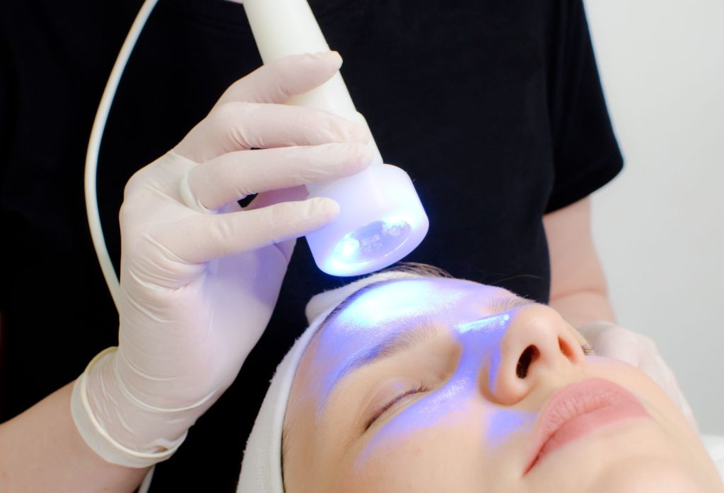 Person getting blue light therapy on the face