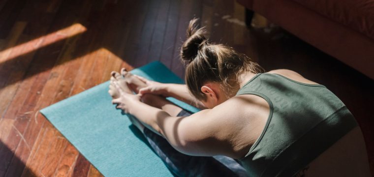 woman doing yoga to help prevent spider veins