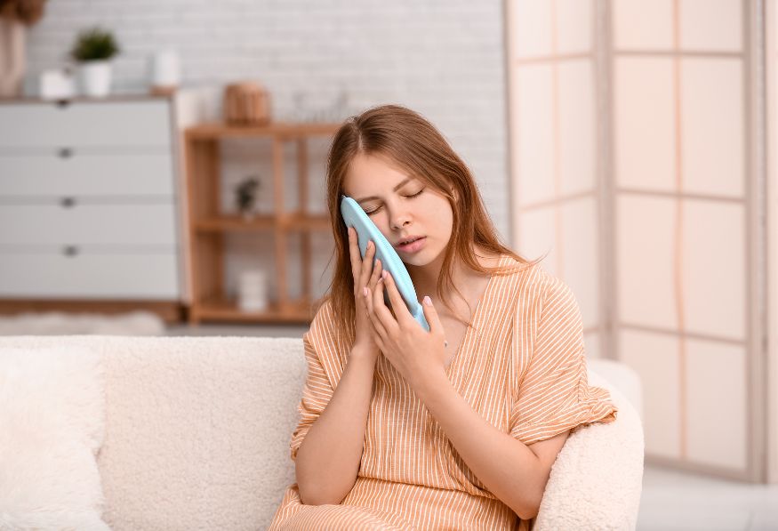 woman applying a cool compress to her face after botox treatment